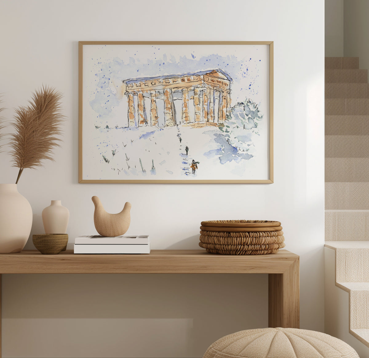 Penshaw Monument in winter watercolour, displayed in a light wooden frame, snow-covered hillside with children walking up toward the monument