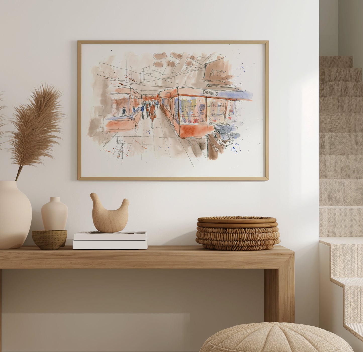 Jackie White's Market Sunderland watercolour artwork displayed in a frame on a wall, showing the busy market scene and characterful stalls, by Stephen Darling Art